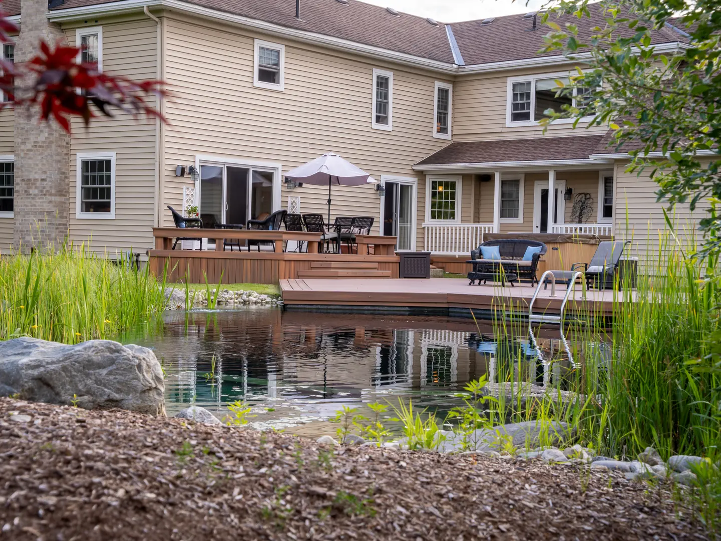 Rear exterior viewed across the pond garden.