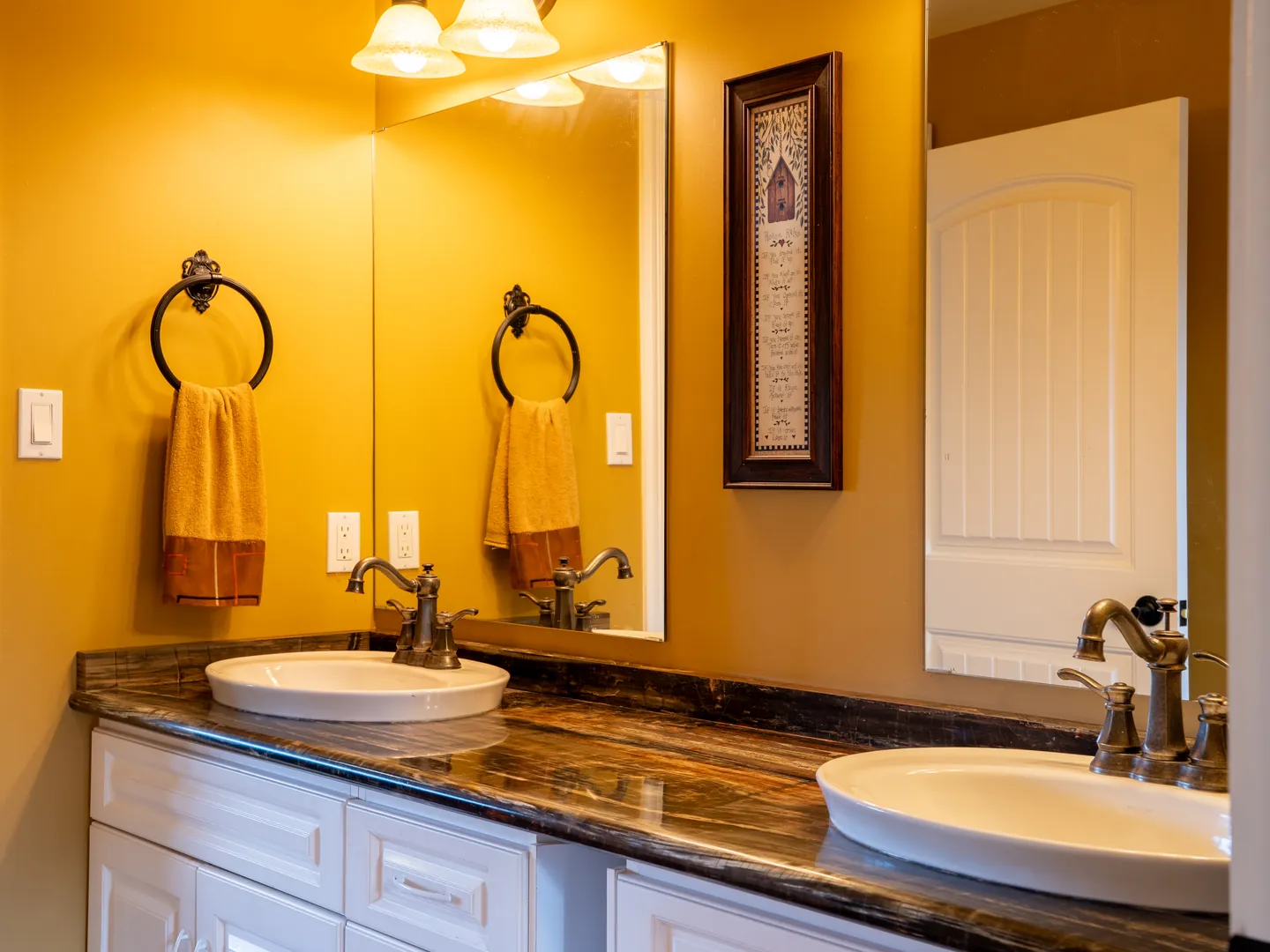 Double vanity with a dark stone counter